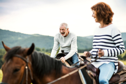 Middle-aged man and woman riding horses