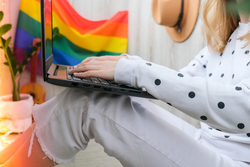 Woman working in office with LGBT decor and accessories