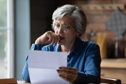 Stressed woman reading documents