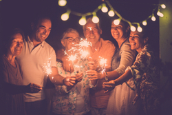 a group of people with sparklers celebrating the new year