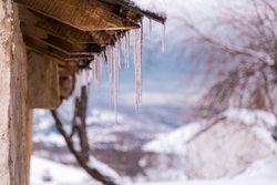 close up of icicles hanging from a rooftop