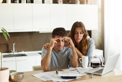 Couple looking concerned about their finances