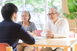 Older couple speaking with an adviser