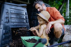 A father and daughter composting