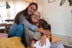 Multiple generations of a family hugging