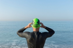 A man preparing to swim in the sea.