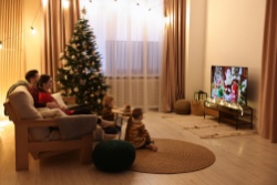 A family watching TV on Christmas.