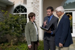 An older couple speaking to an estate agent.