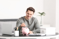 A man saving in a piggy bank.