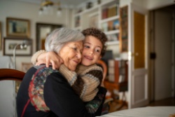 A woman hugging her grandchild. 