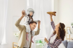 A couple playing with their child.