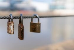 Three padlocks on a chain.