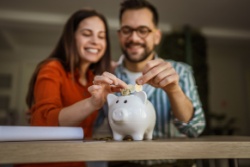 A couple saving in a piggy bank.